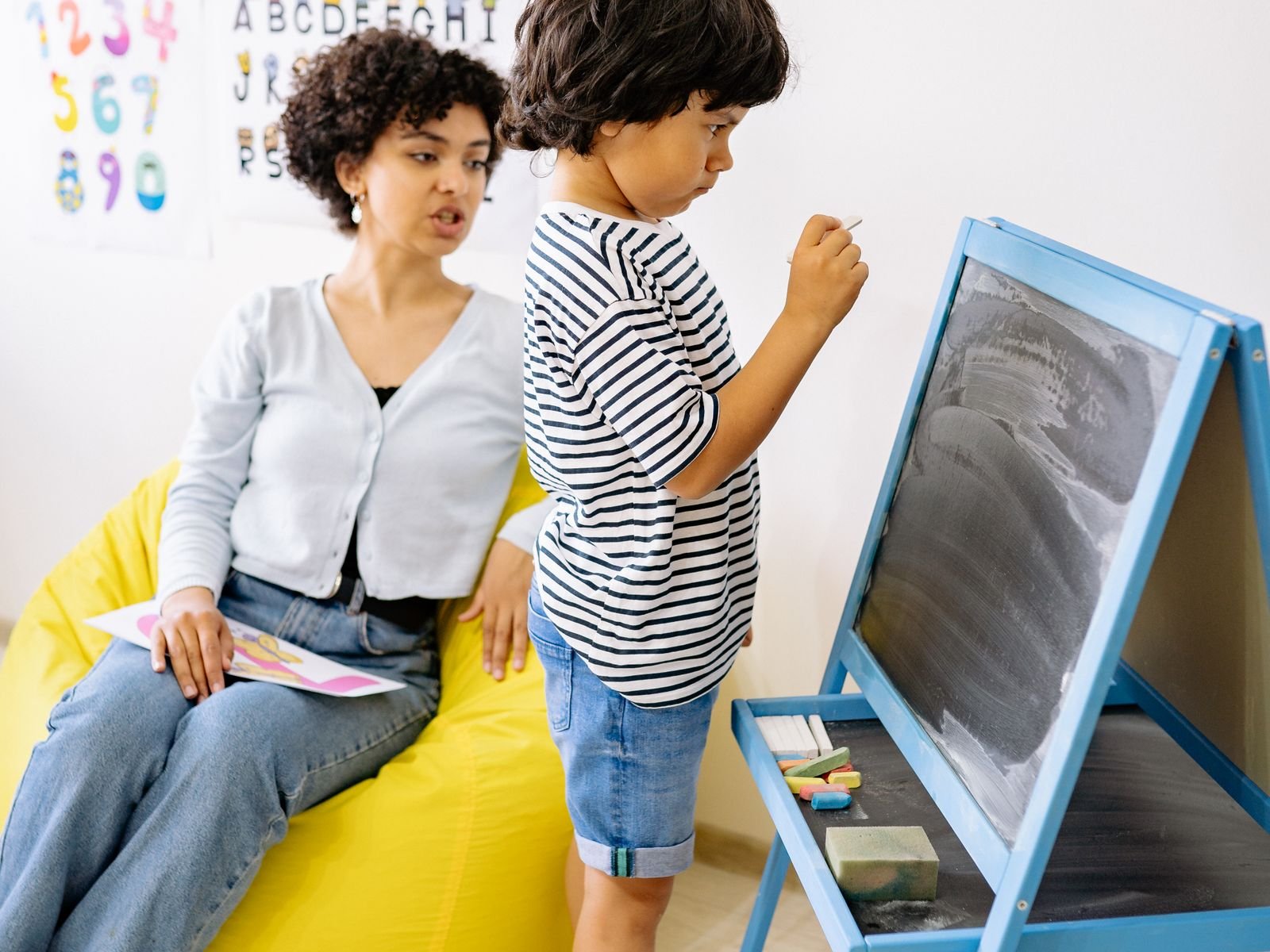 Therapist working with a child in a supportive learning environment